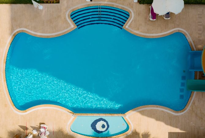 Aerial view of swimming pool outside hotel. Beautiful pool ready to holiday tourists.