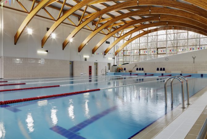 Indoor swimming pool with marked lanes, flat calm water